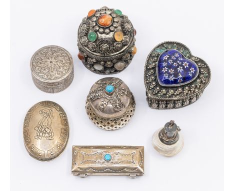 A collection of silver and white metal pill boxes and scent bottle, including an Eastern example with porcelain heart shaped 