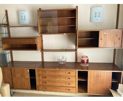 A collection of late 1960s teak to include a pair of bedside drawers, ladder wall unit and wall cupboards with sliding doors.