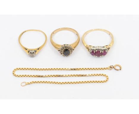 A ruby and diamond set 9ct gold ring, sety with three oval mixed cut rubies within diamond set borders, width approx 8mm, siz