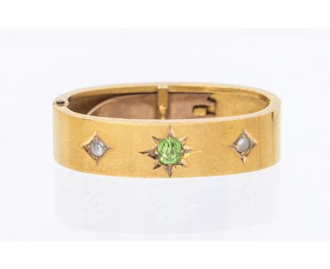 A Victorian peridot and diamond set 15ct gold scarf/cravat clip, star set to the centre with a oval peridot, small rose cut d