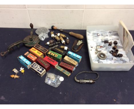 A collection of boxed and loose vintage car spark plugs, gauges and other vintage car items.