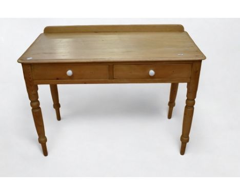 A Victorian pine wash stand made by Heals &amp; Co, with two top drawers, turned legs and ceramic handles.