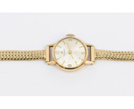 Tissot- a ladies 9ct gold watch wristwatch, comprising a round silvered dial with applied and quarter numeral  baton markers,