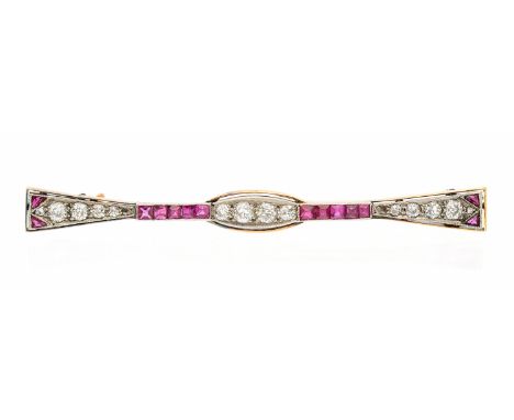An Edwardian synthetic ruby and diamond gold brooch, comprising a bow like shape, the centre set with grain set graduated dia