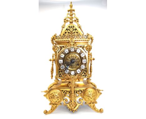 A 20th century French ormolu mantel clock of ornate design, complete with key, 45cm