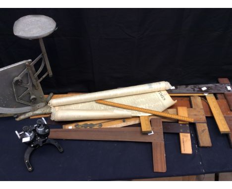 A collection of T.D. T square's wooden vintage rulers, 1950s scales and microscope and vintage 1930s newspapers.