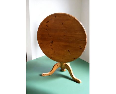 A tilt top round breakfast table with four chairs in pine along with two folding card tables.