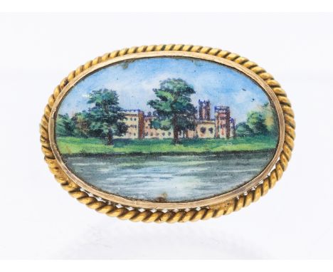 A silver gilt porcelain brooch, oval form with painted scene depicting a stately home river scene, within a rope border, leng