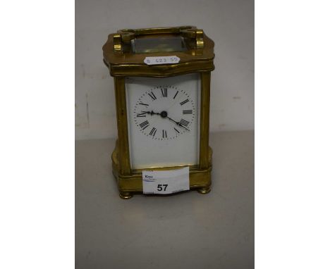 French carriage clock in a brass serpentine form case