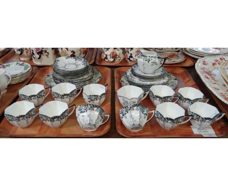 Two trays of Shelley English china 'Black Trees' design teaware to include: teacups, saucers, plates, serving dishes and milk