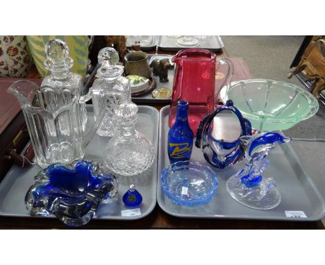 Two trays of glassware to include: green glass pedestal bowl with metal base, dolphin ornament, cranberry glass lemonade jug,