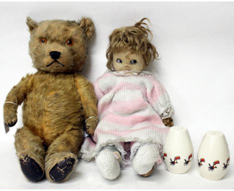 AN EARLY 20TH CENTURY MOHAIR AND STRAW FILLED TEDDY BEAR and a Chad Valley doll and a pair of Carltonware Guinness salt and p