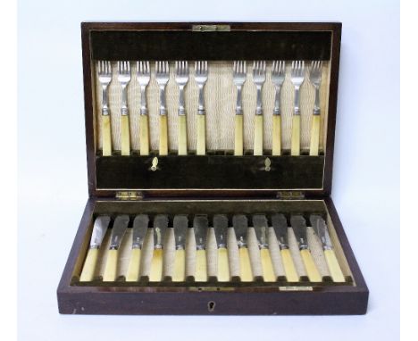 A WALKER & HALL 23 PIECE SILVER CANTEEN  of fish knives and forks, each with ivory handles and marks for Sheffield 1931(one f