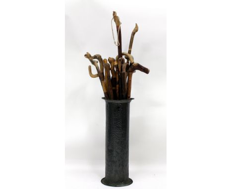 A COLLECTION OF OLD WALKING CANES  to include a horse measuring stick and a hammered tin stick stand 