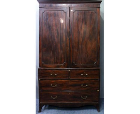 A 19TH CENTURY MAHOGANY LINEN PRESS with panelled doors enclosing five slides within over two short and two long drawers stan