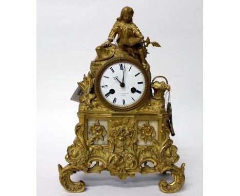 A 19TH CENTURY FRENCH F.L.HAUSEBURG GILT METAL MANTLE CLOCK with white enamel dial and black Roman numerals, the case depicti