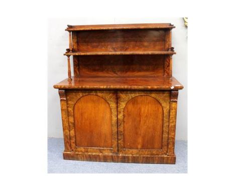 AN EARLY VICTORIAN FLAME MAHOGANY CHIFFONIER the raised back with two shelves and turned supports above two doors and raised 