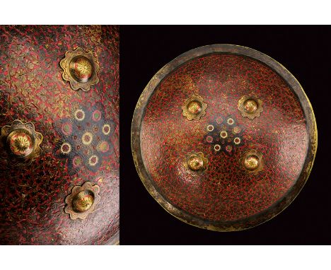 dating: late 19th Century provenance: India Circular, convex, brass dhal with flat, external edge. The front richly decorated