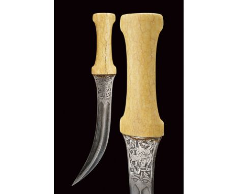 dating: 19th Century provenance: Indopersia Curved, double-edged blade featuring a fine damask raiser at the centre, carved w