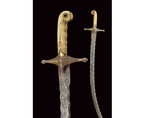 dating: 19th Century provenance: Indopersia Interesting, curved, single-edged, undulated blade with gilt, double tip, the bac
