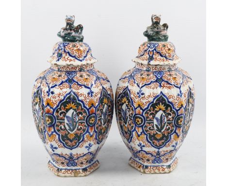 A pair of Delft pottery jars and covers, 18th/19th century with chinoiserie decoration and lion finials, height 26cm1 jar has