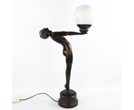 A reproduction Art Deco style composition lamp, in the form of a naked figure with marbled glass ball shade, overall height 7