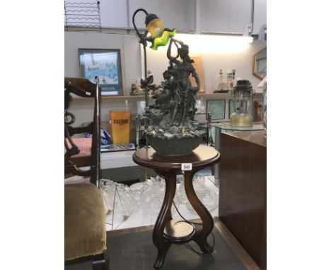 A Tiffany style figure group lamp on side table