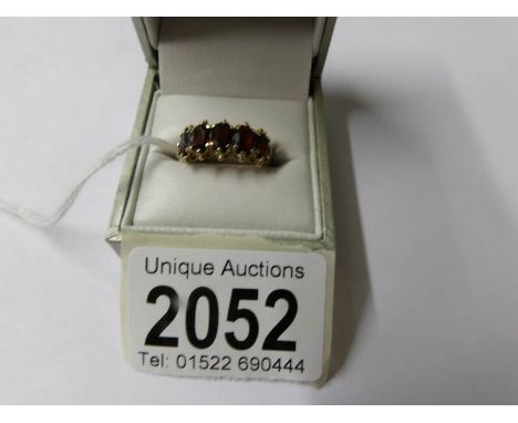 A 9ct gold ring set garnets, size K half.