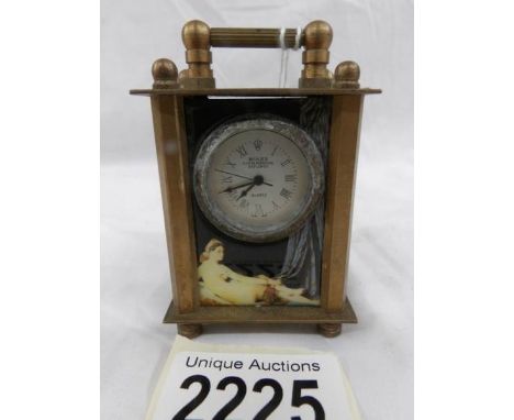 A miniature brass carriage clock with figure decorated panels.
