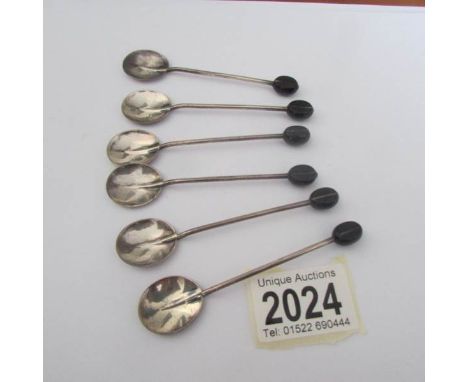 A cased set of six silver spoon with coffee bean finials.