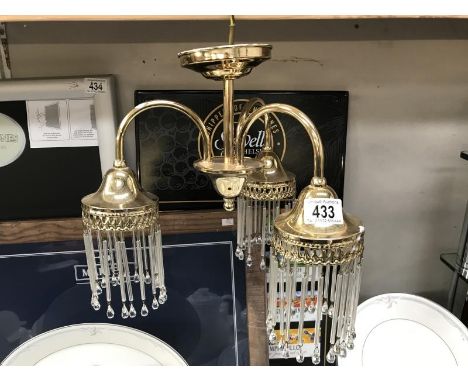 A brass effect 3 arm ceiling light.