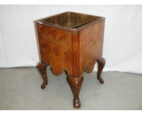 A small Victorian walnut planter on cabriole legs.