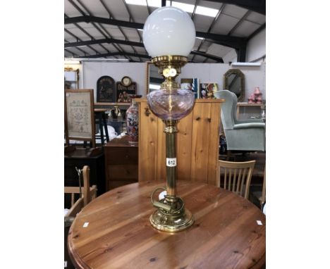 A brass table lamp in the form of an oil lamp.