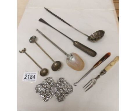 A mixed lot including plated nurses buckle, 19th century ladle, spoons etc.,