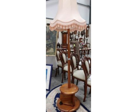 An oak standard lamp with shade.
