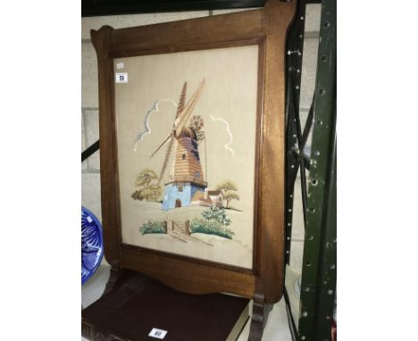 A tapestry of a windmill in a mahogany frame.