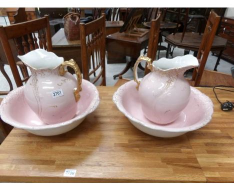 A pair of pink jug and basin sets, a/f.