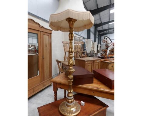 A gilded standard lamp with shade.