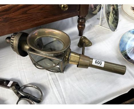 A brass carriage lamp.