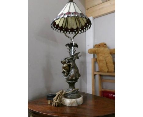 A cherub table lamp with Tiffany style shade.