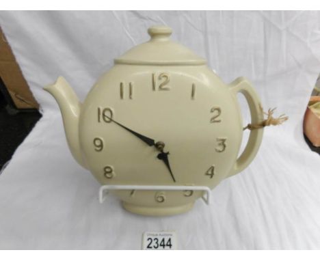 An unusual retro clock in the shape of a teapot.