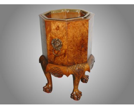 A Victorian walnut planter with ball and claw feet.