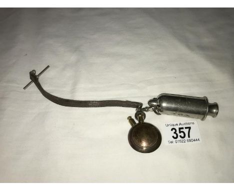A trench art lighter and a ww1 anti gas whistle (the acme siren).