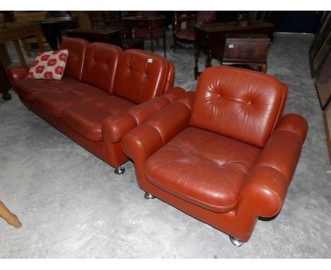 A tan leather 3 seat sofa with matching arm chair.
