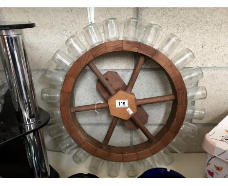 A spice rack in the shape of a ships wheel.