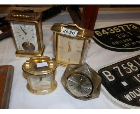 A brass carriage clock and 3 other clocks.