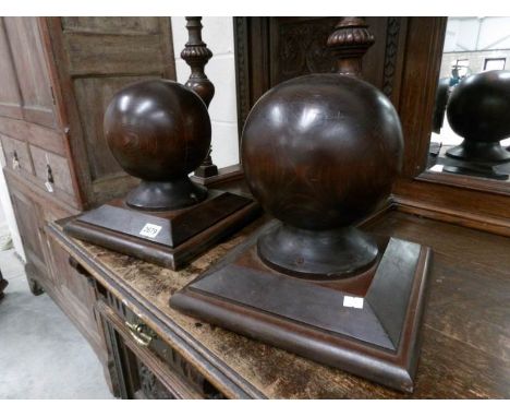 A pair of globe shaped wood staircase finials.