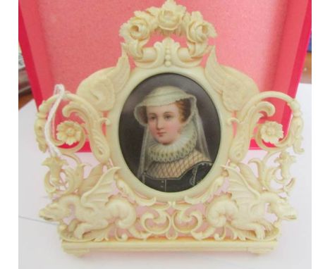 An early Victorian hand painted miniature portrait in a carved ivory frame.