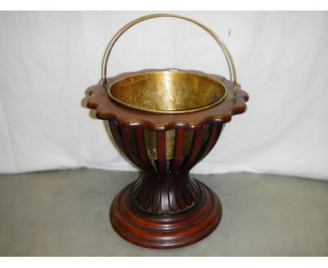 A circular Victorian mahogany planter with scalloped edge complete with brass liner.