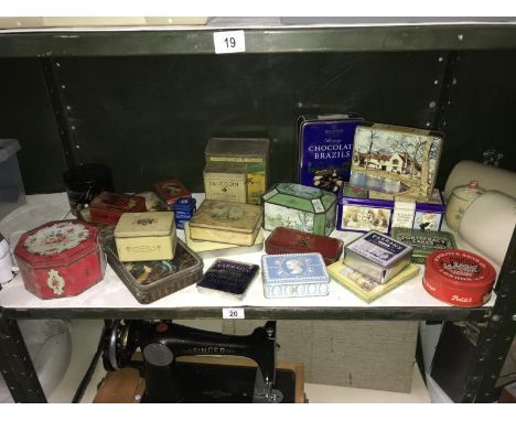 A shelf of collectors tins.